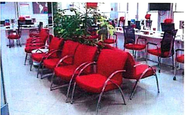 Furnished institutional lounge with red seating